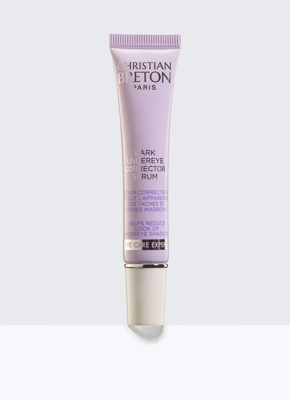 Un tubo morado de sombra de ojos christian deton está colocado sobre una superficie blanca.
