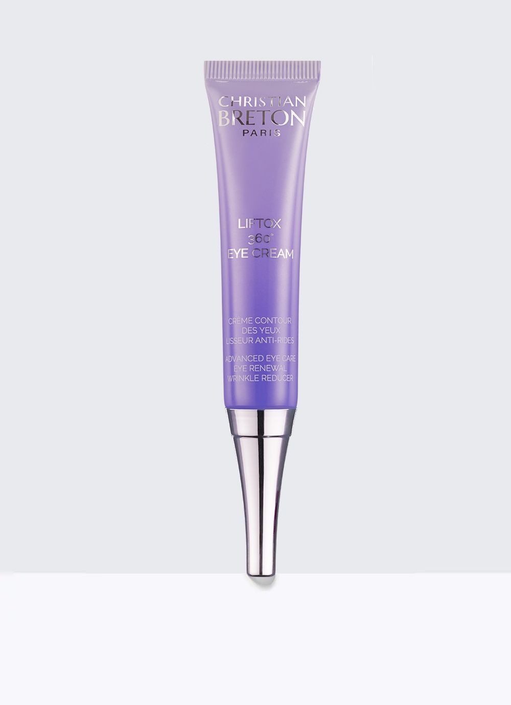 Un tubo morado de brillo labial está colocado sobre una superficie blanca.