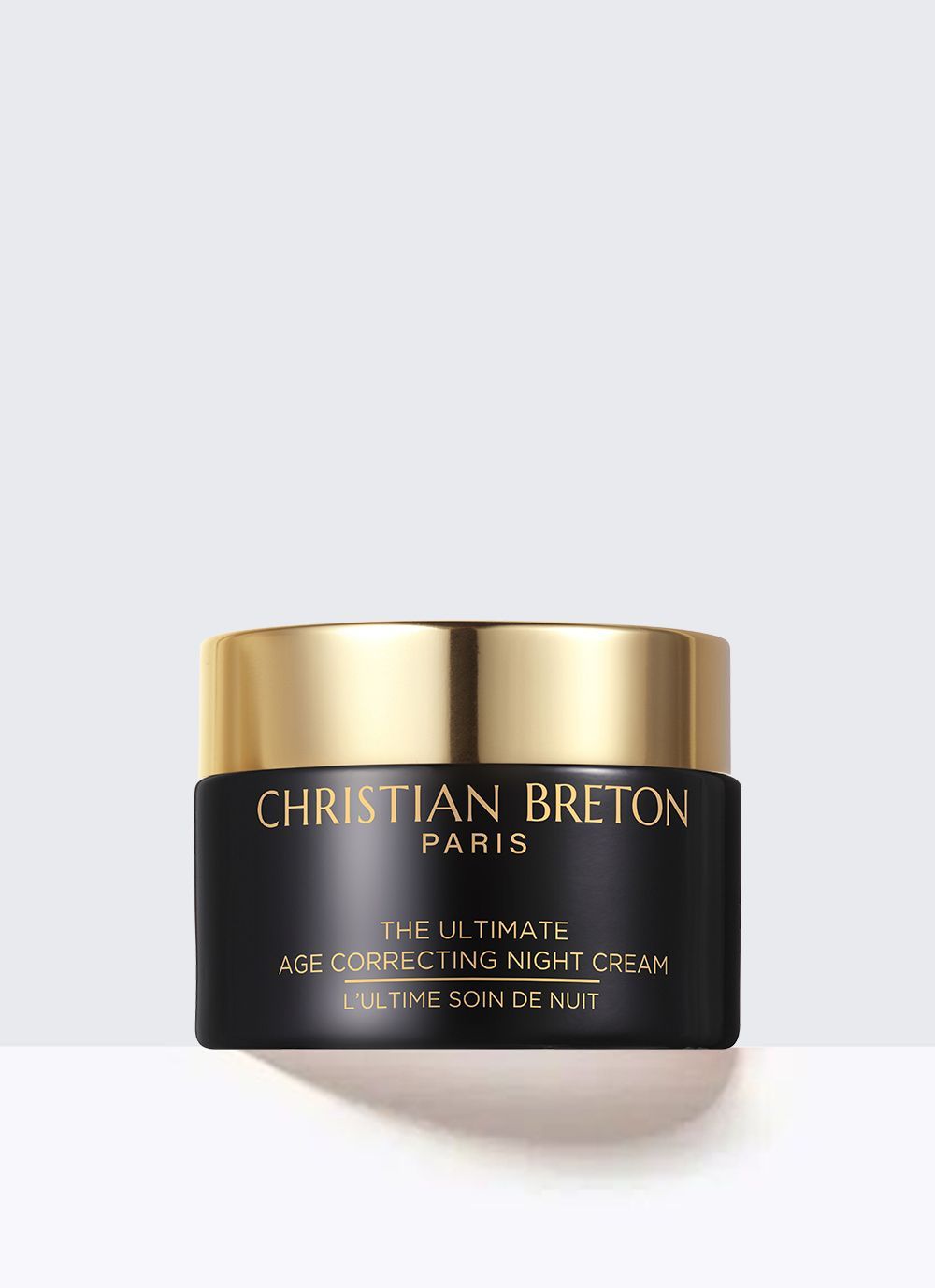 Un tubo morado de crema para ojos christian breton sobre un fondo blanco.