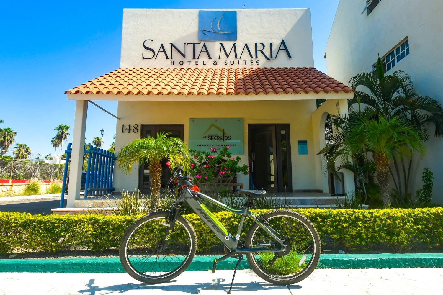 A bicycle is parked in front of a building that says santa maria