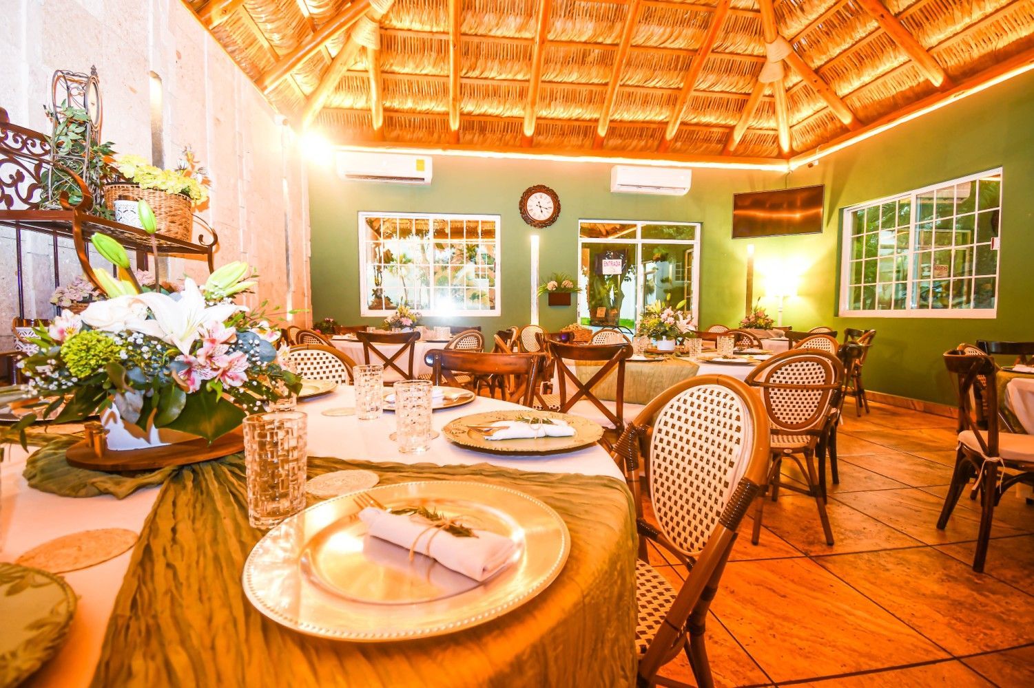 A restaurant with tables and chairs set up for a wedding reception.