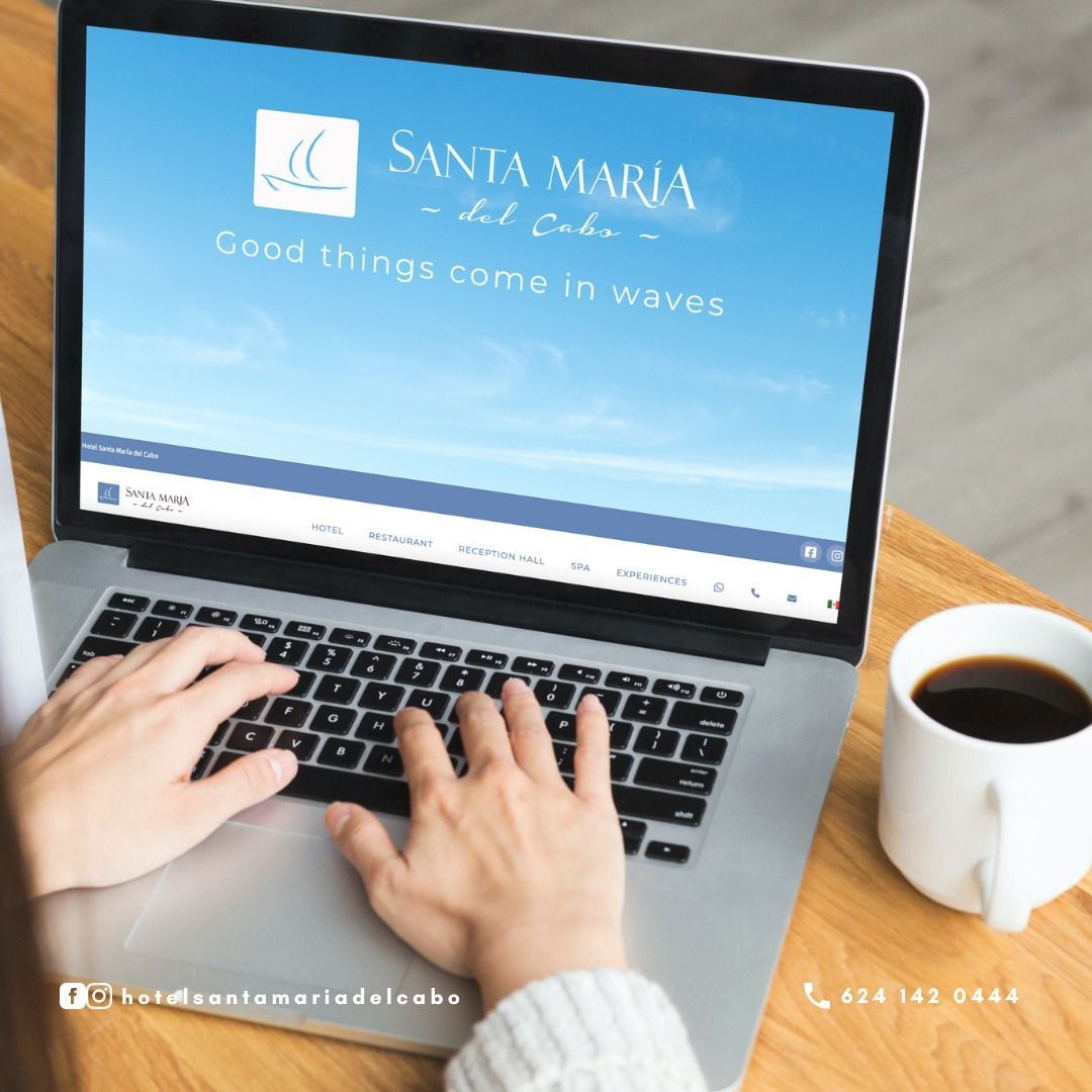 A person is typing on a laptop with santa maria on the screen