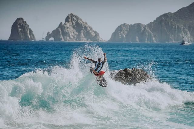 A man is riding a wave on a surfboard in the ocean.
