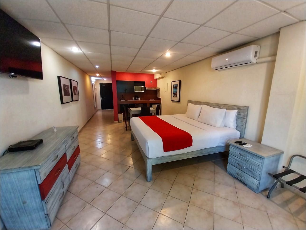 A hotel room with a large bed and a flat screen tv