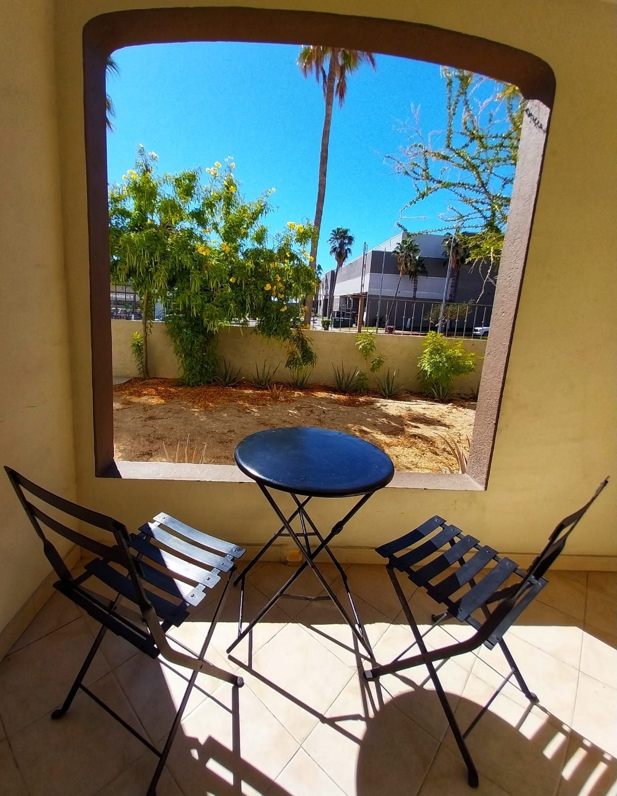 Two chairs and a table in front of a window