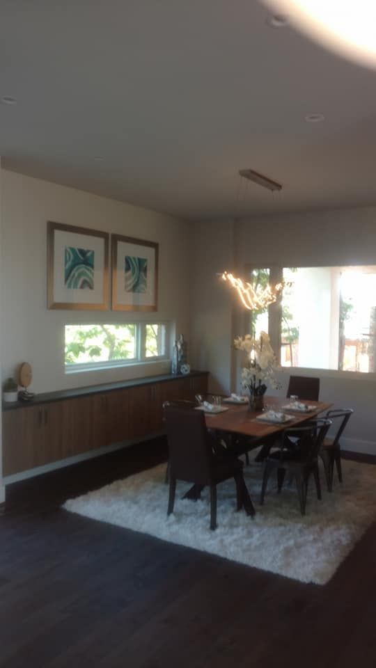 A Dining Room With A Table And Chairs And A Rug | Littleton, CO | All Phase Construction Company LLC