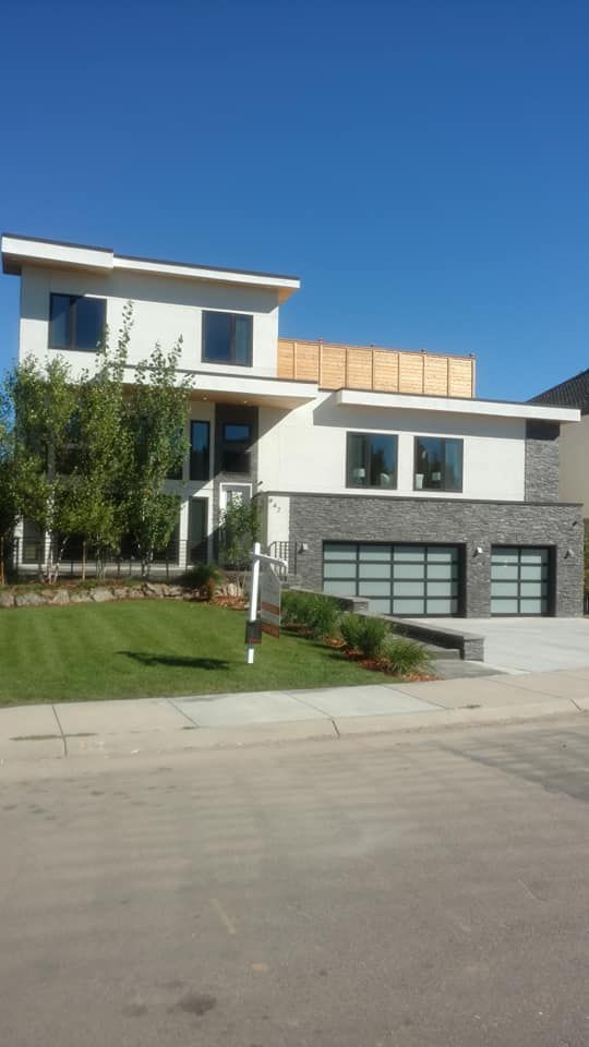A Large White House With A Wooden Fence On Top Of It | Littleton, CO | All Phase Construction Company LLC