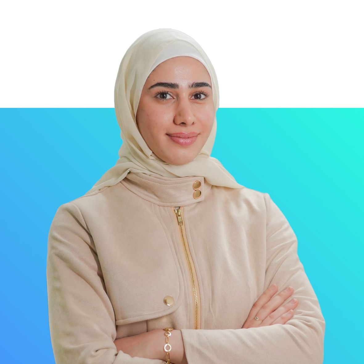 A woman wearing a hijab is standing with her arms crossed