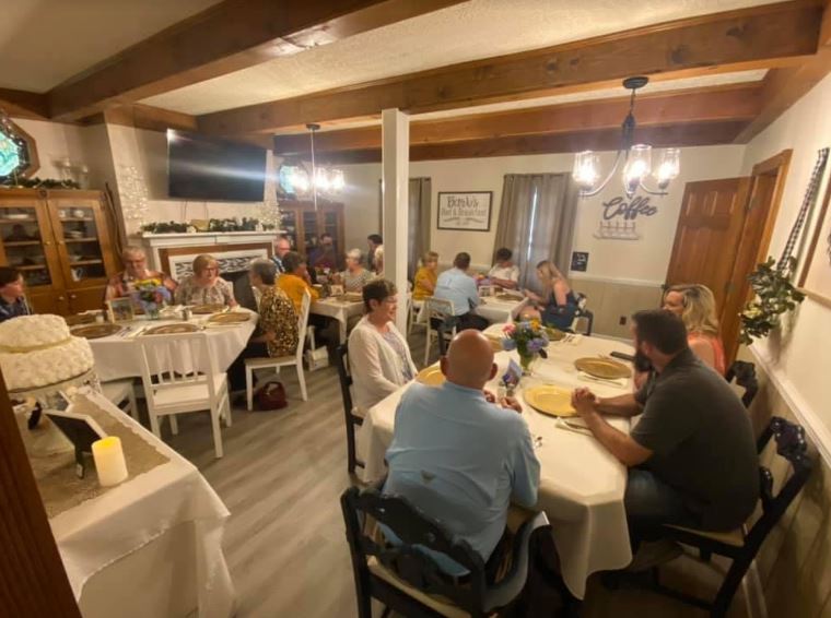 A group of people are sitting at tables in a room.