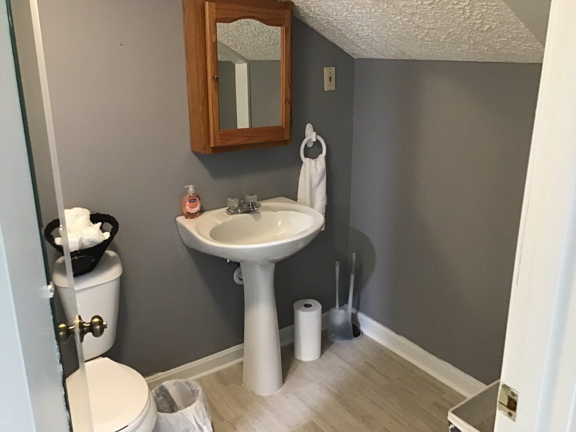 A bathroom with a sink , toilet and mirror.