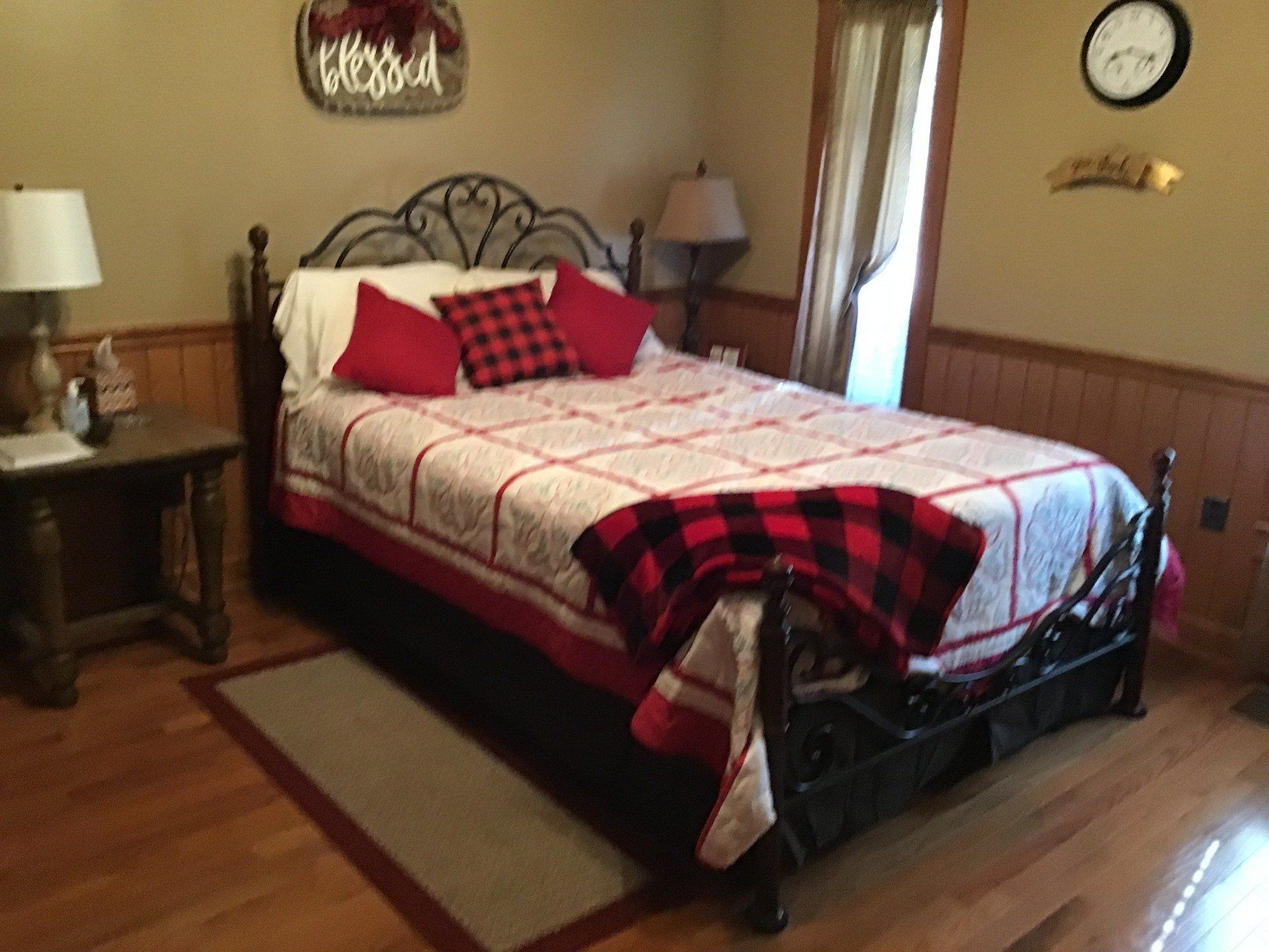 A bedroom with a bed and a sign that says home