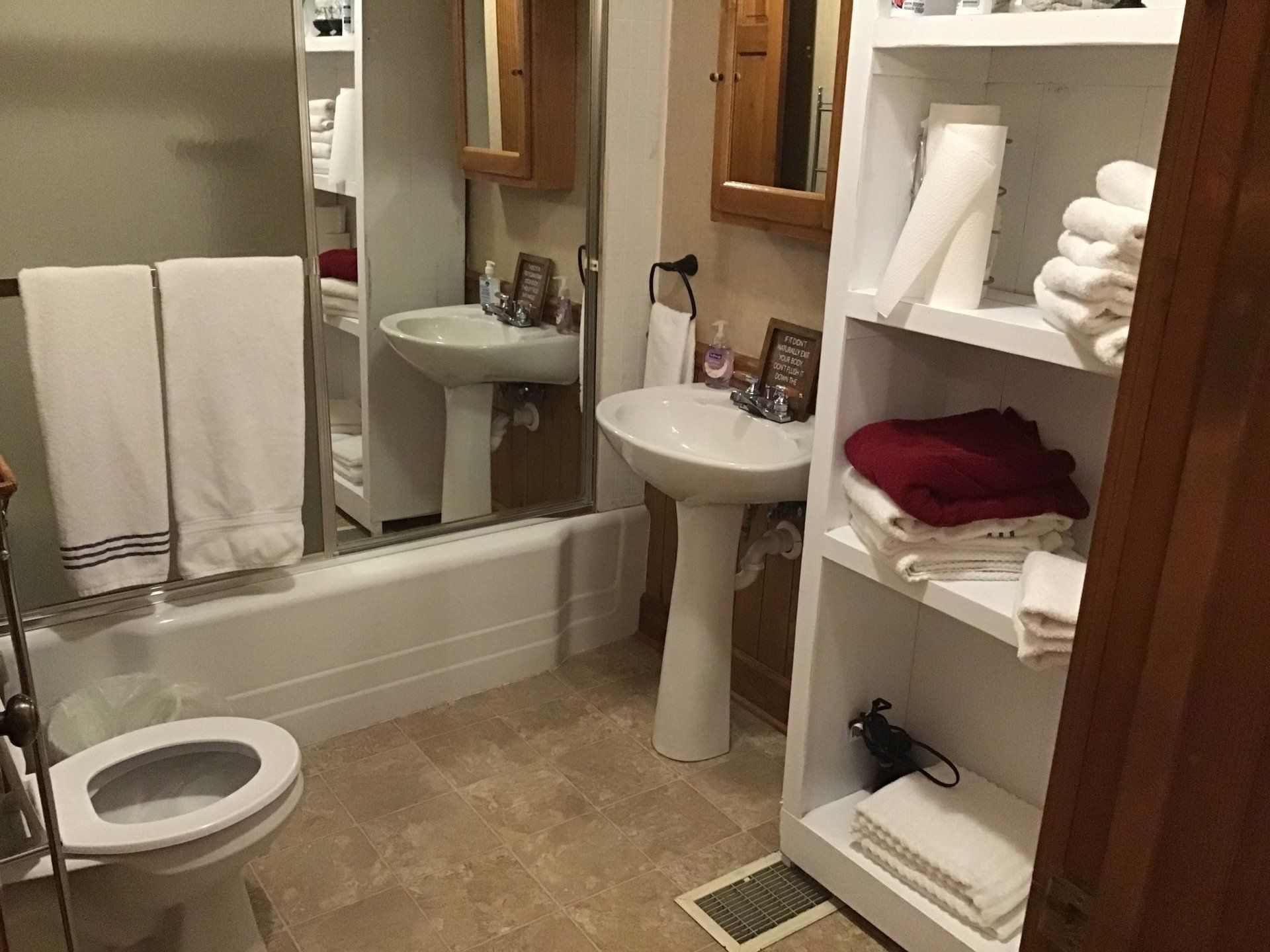 A bathroom with a toilet , sink , and bathtub.