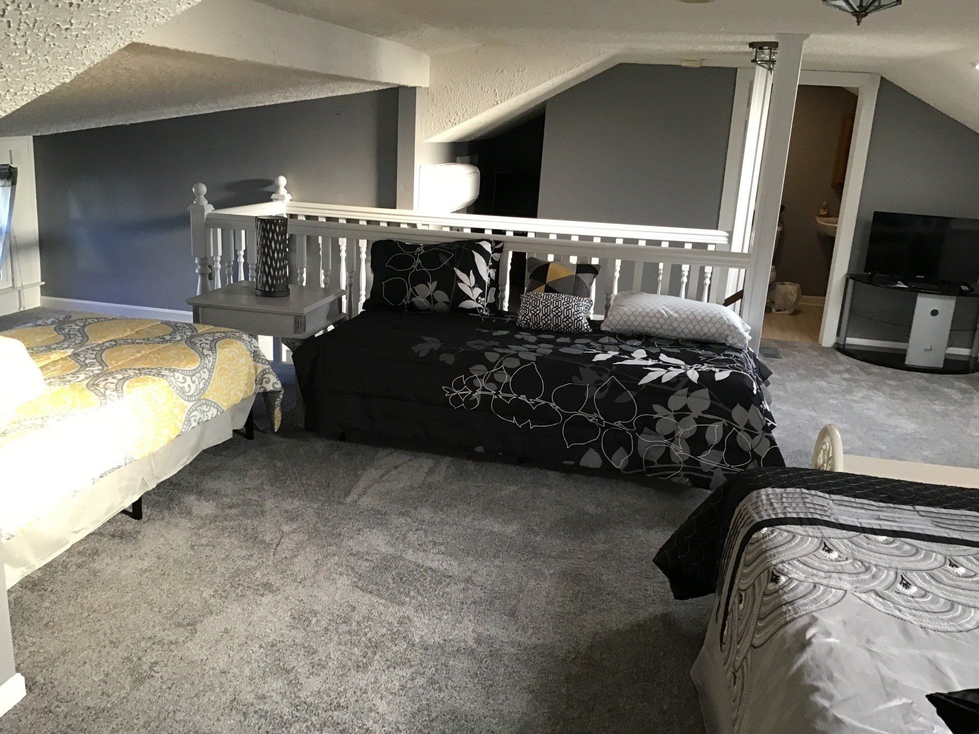 A bedroom with two beds and a couch in it