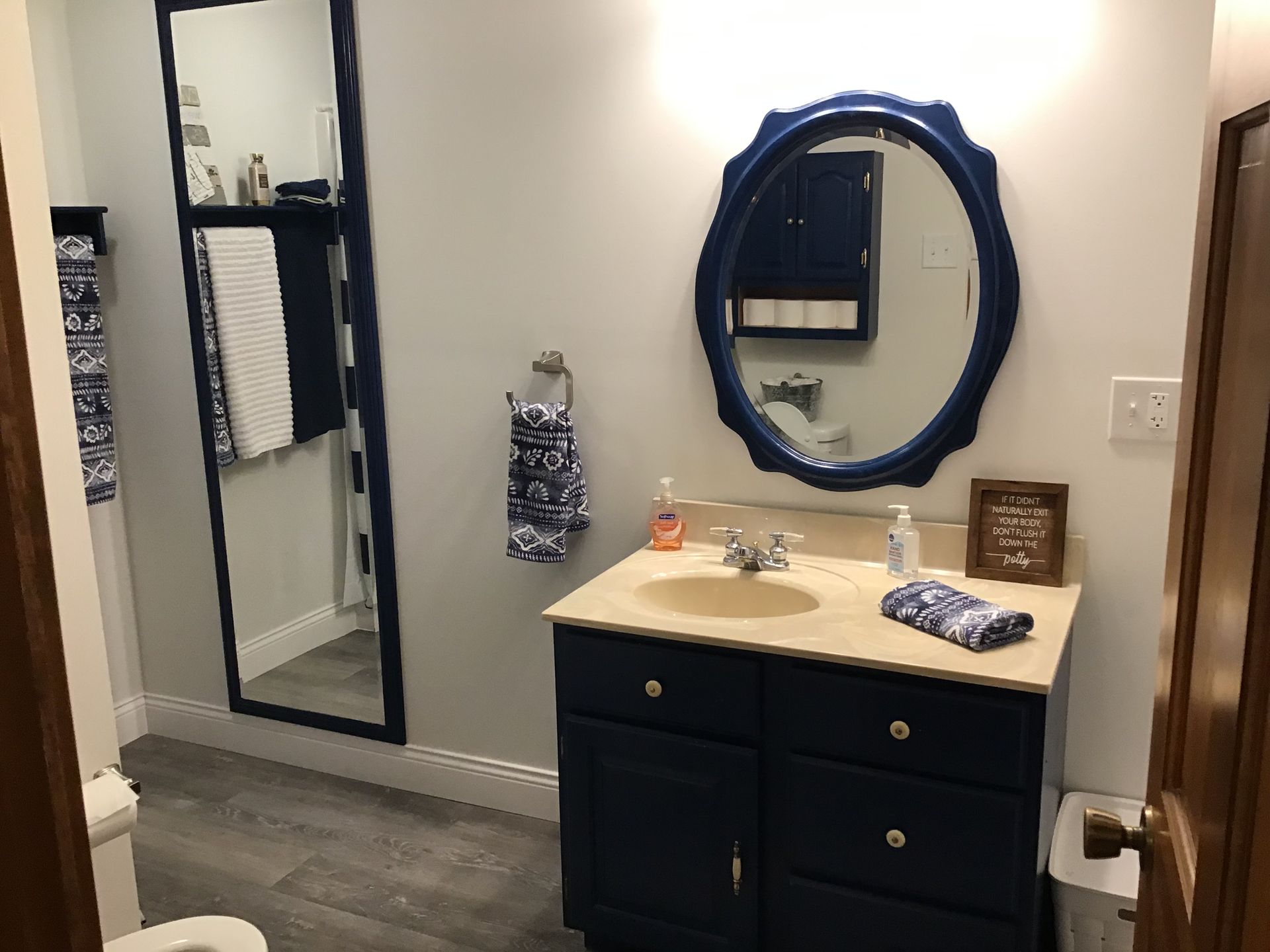 A bathroom with a sink , mirror and toilet.