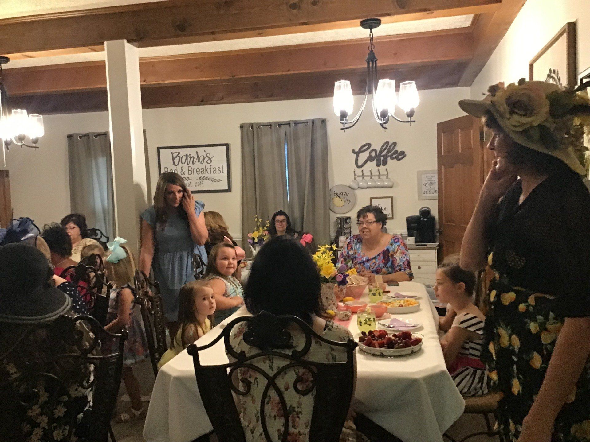 A group of people are sitting around a table in a room.