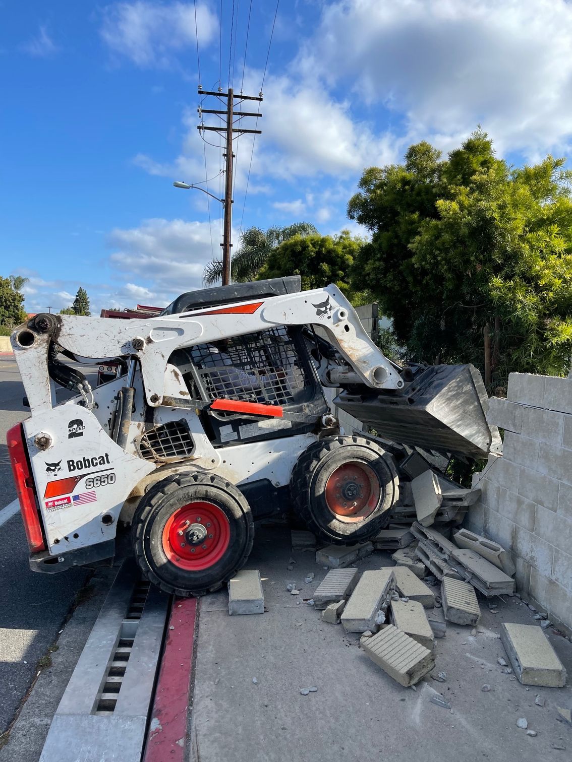A couple of men are working on a brick walkway.