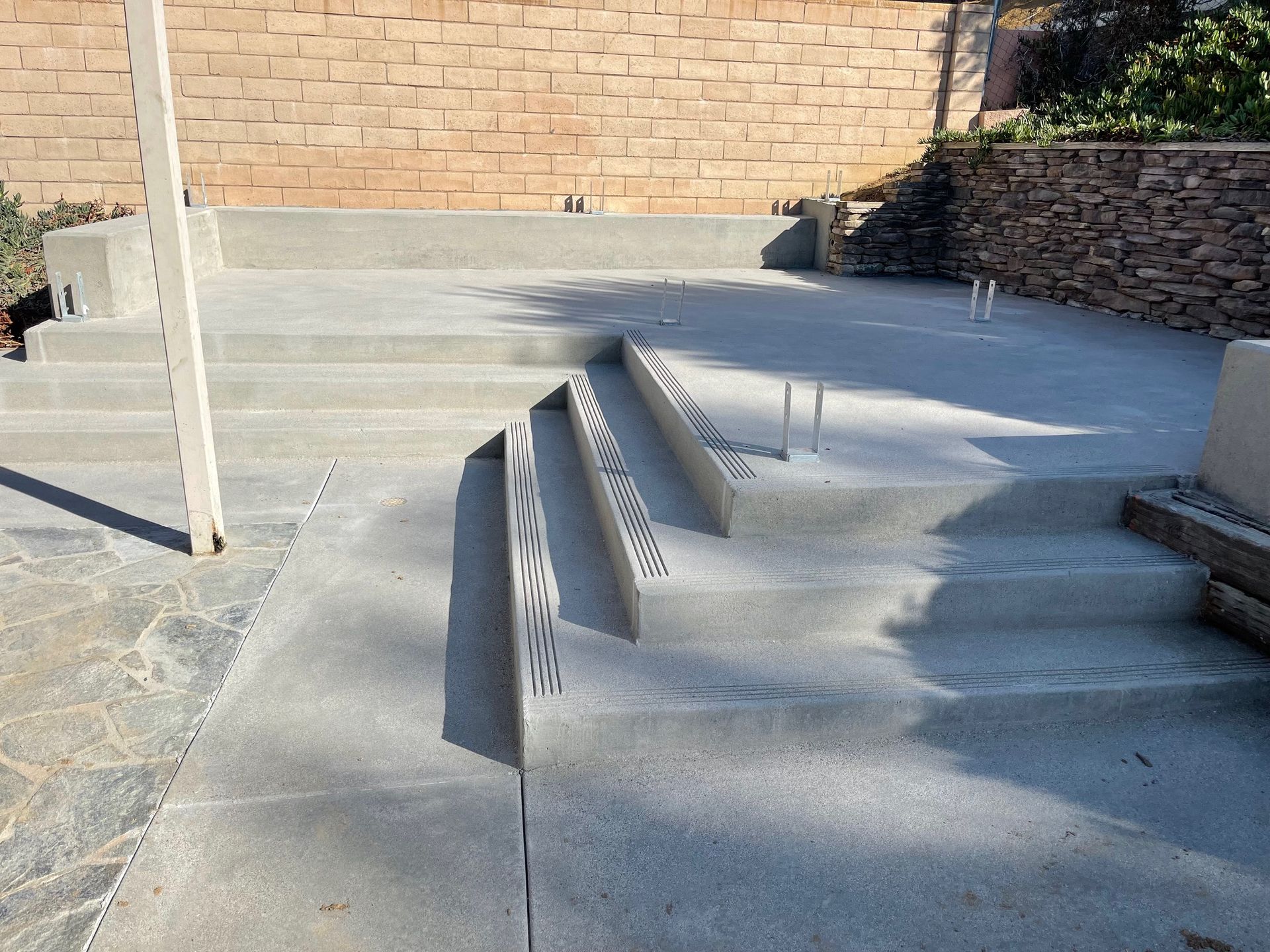 A man is leveling a concrete floor with a level.