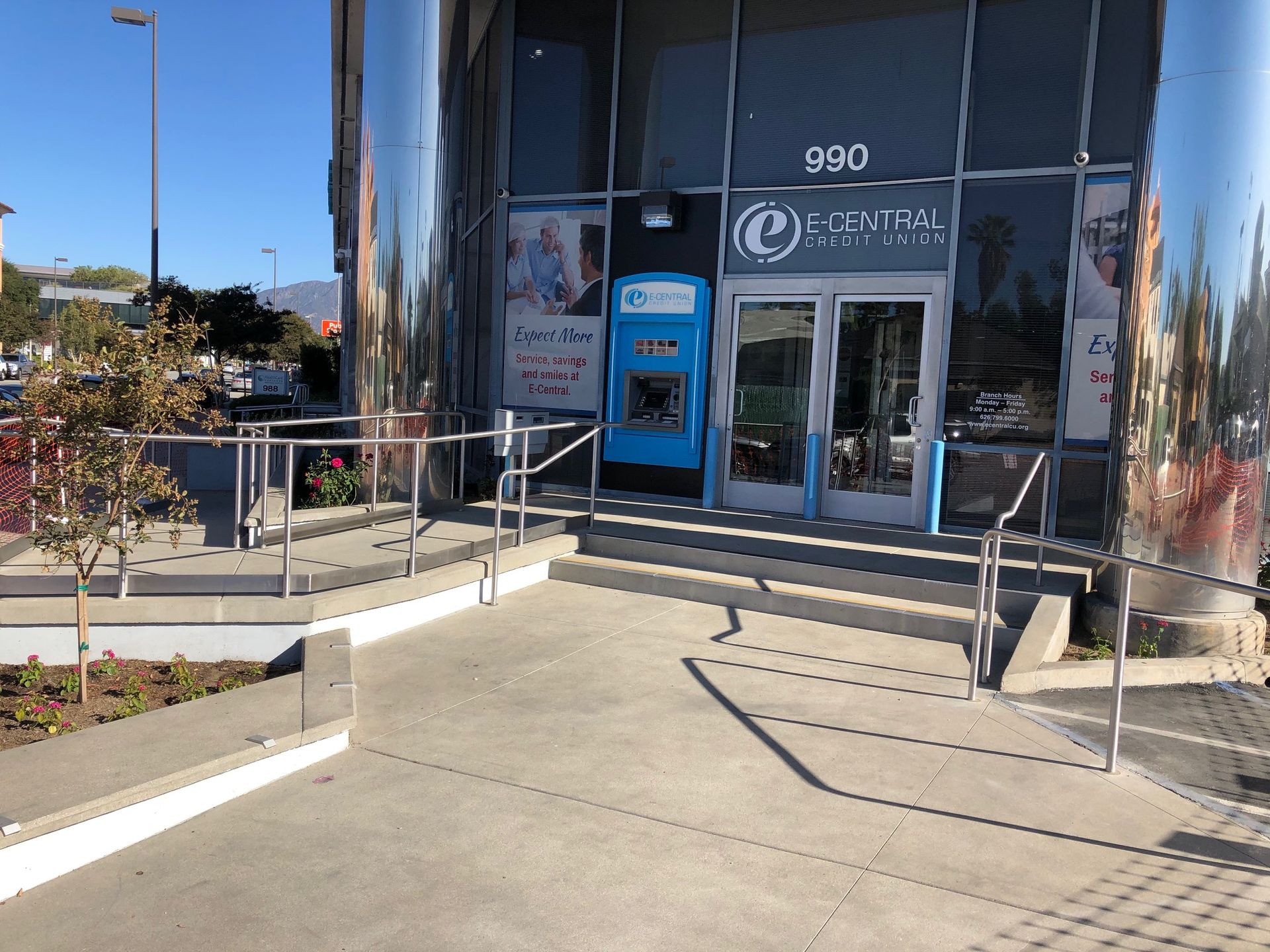 A construction worker is kneeling down on a brick walkway.