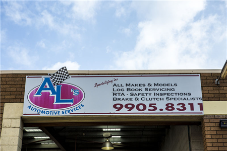 A sign that says al 's automotive services on it