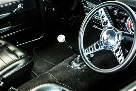 A close up of a steering wheel in a car