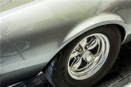 A close up of a car wheel with a continental tire