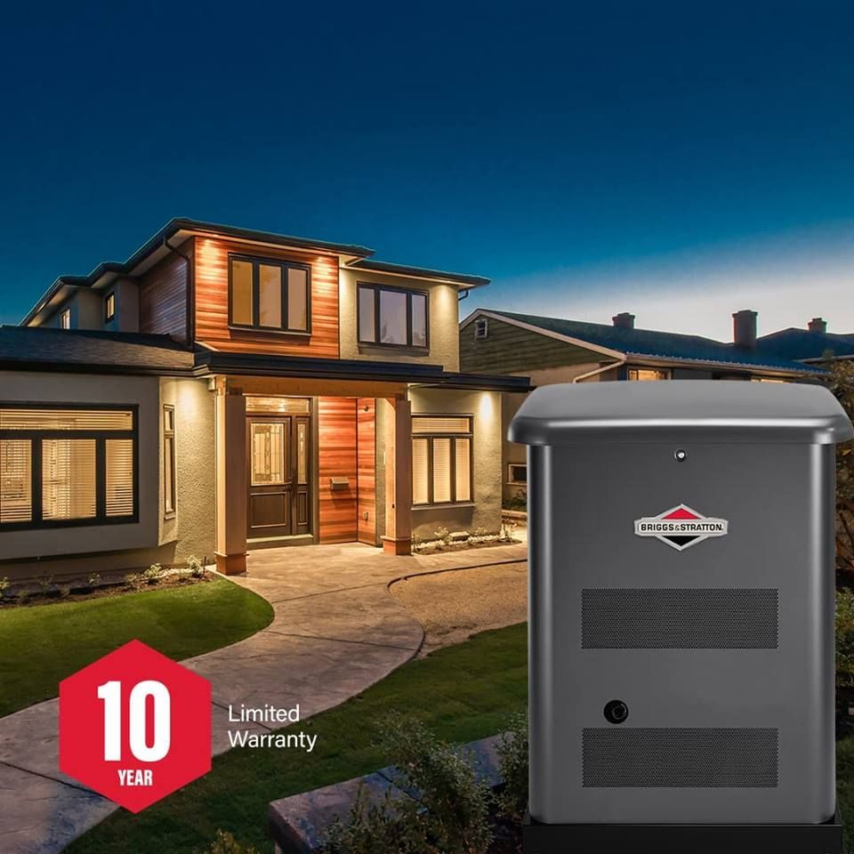 A house with a generator in the yard at night, with a 10-year limited warranty badge.