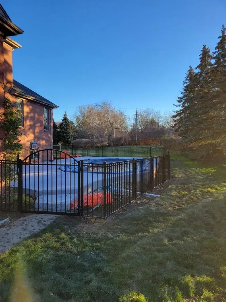 A metal fence installation in Troy, MI around a pool by Elite Wood Fencing