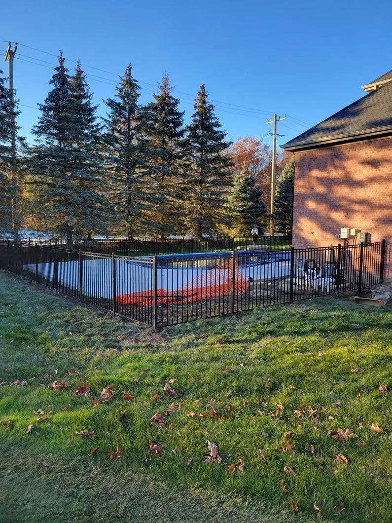 A metal fence installation in Troy, MI by Elite Wood Fencing