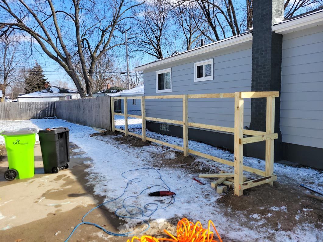 A wood fence in Troy, MI in a backyard in by Elite Wood Fencing