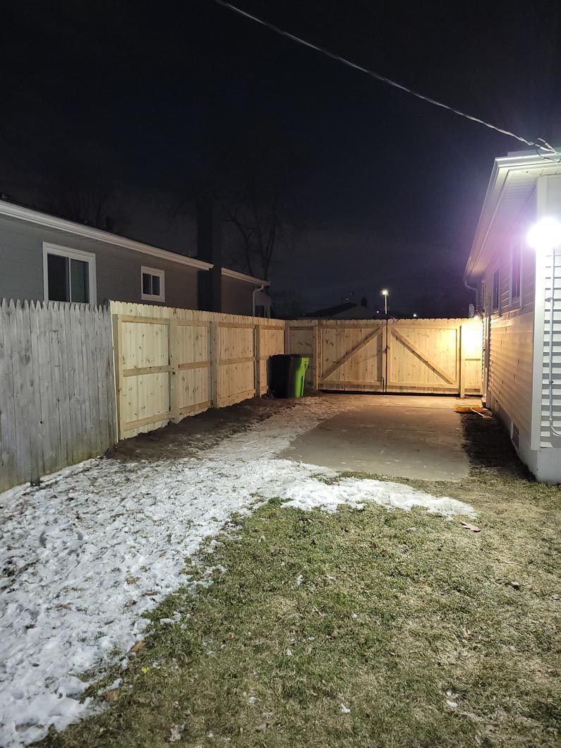 A wood fence in Troy, MI in a backyard in by Elite Wood Fencing
