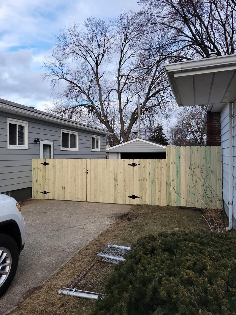 A wood fence in Troy, MI in a backyard in by Elite Wood Fencing