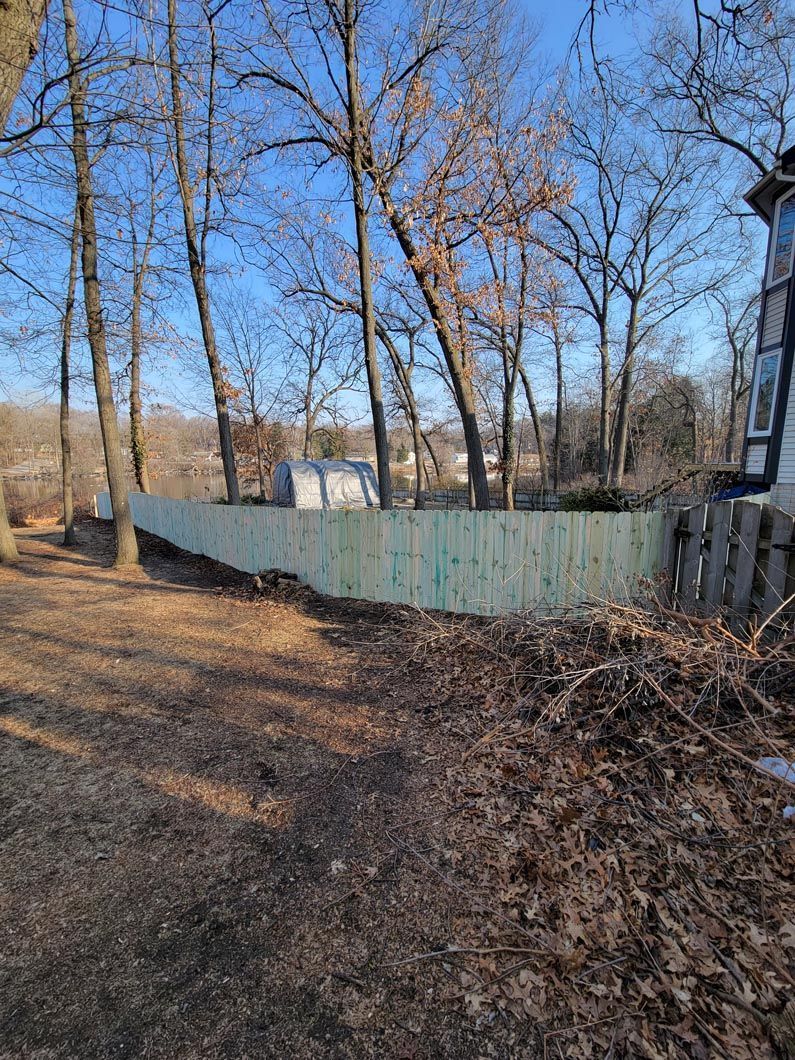 A wood fence in Troy, MI in a backyard in by Elite Wood Fencing