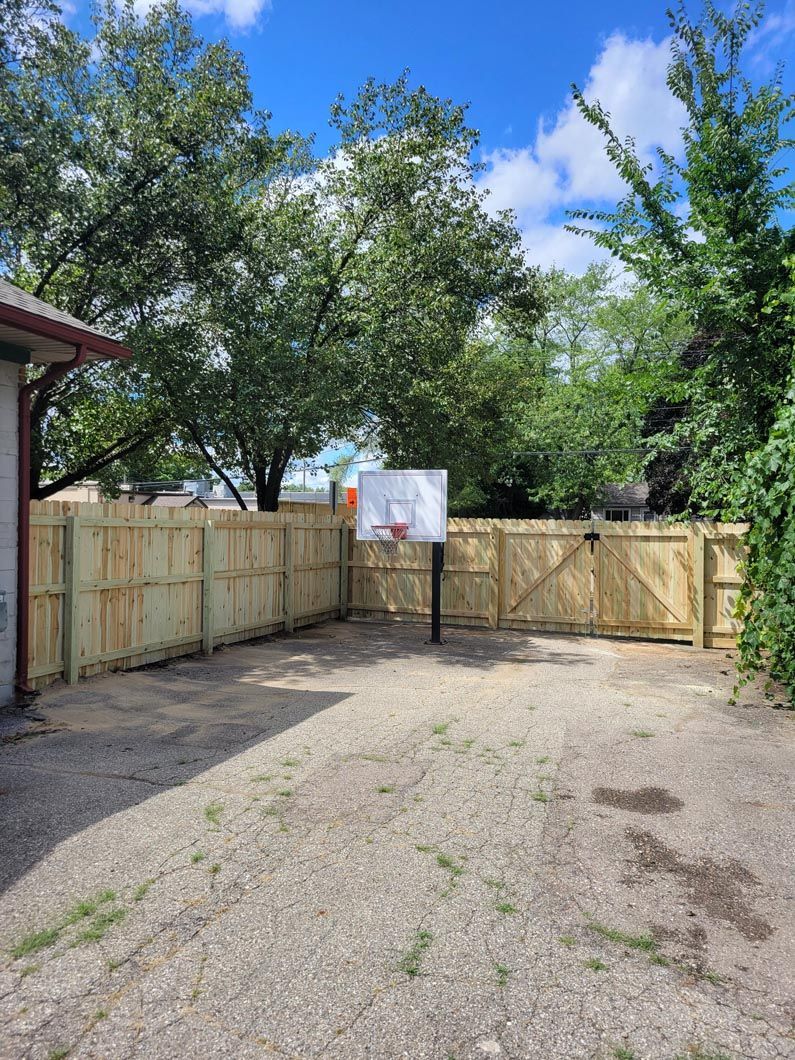 A wood privacy fence in Troy, MI in a backyard in by Elite Wood Fencing