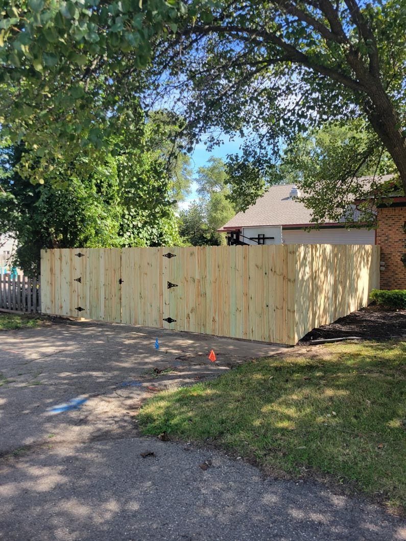 A wood privacy fence in Troy, MI in a backyard in by Elite Wood Fencing