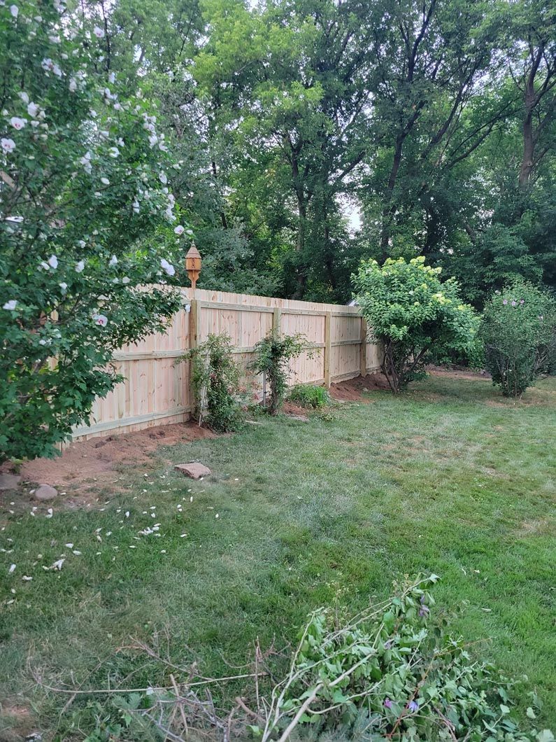 A wood privacy fence in Troy, MI in a backyard in by Elite Wood Fencing