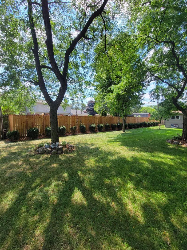 A wood privacy fence in Troy, MI in a backyard in by Elite Wood Fencing