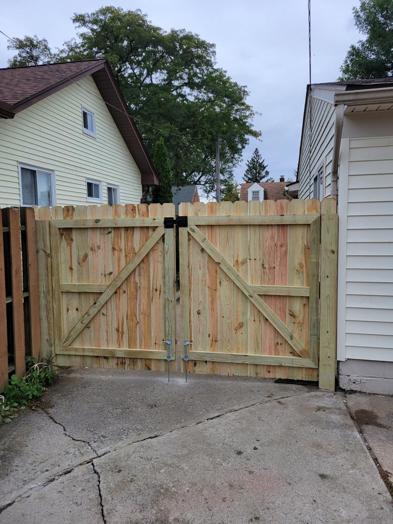 A wood privacy fence in Troy, MI in a backyard in by Elite Wood Fencing
