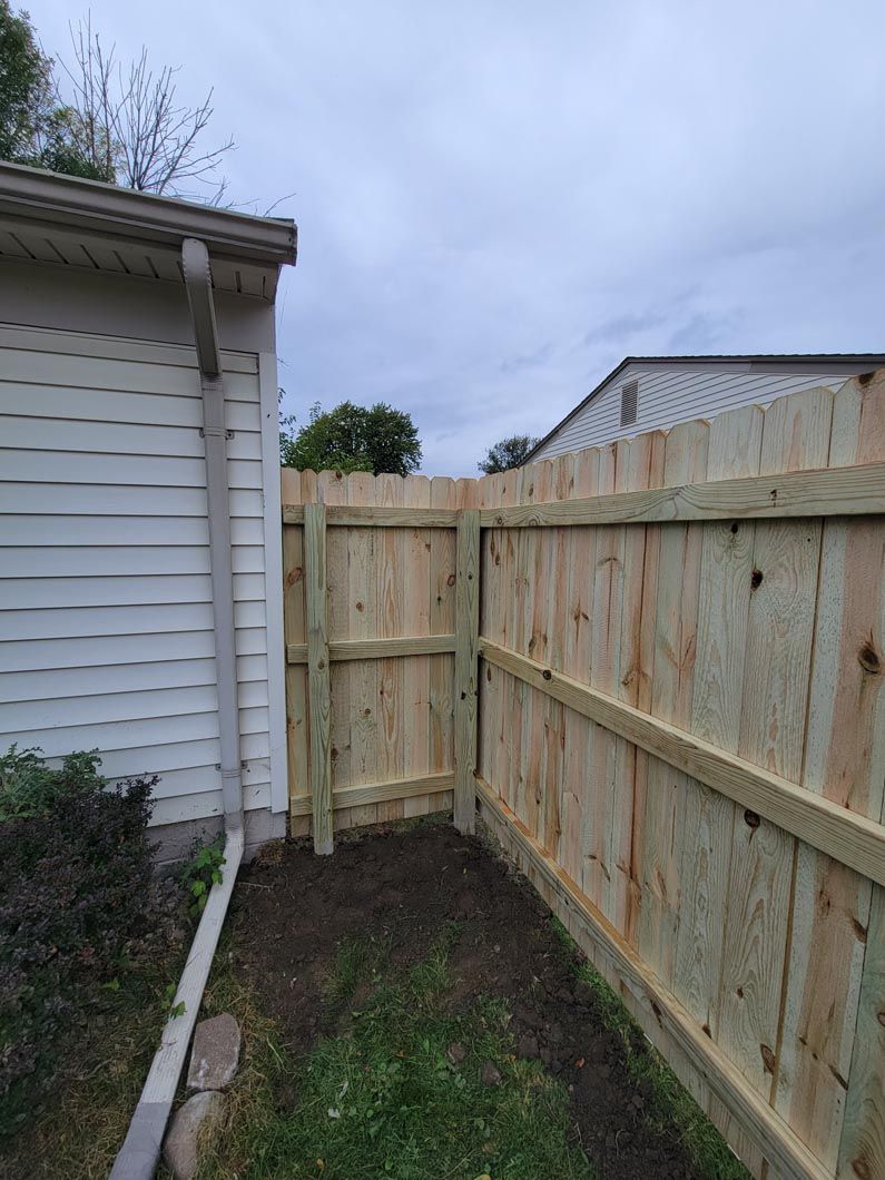 A wood privacy fence in Troy, MI in a backyard in by Elite Wood Fencing