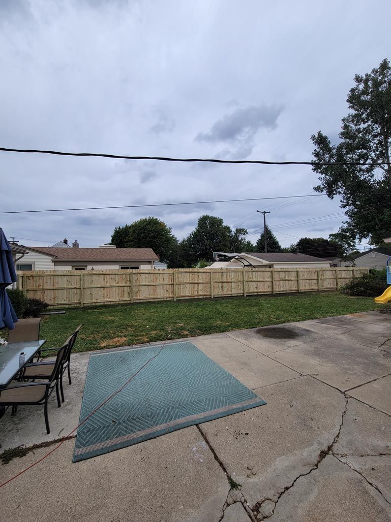 A wood privacy fence in Troy, MI in a backyard in by Elite Wood Fencing