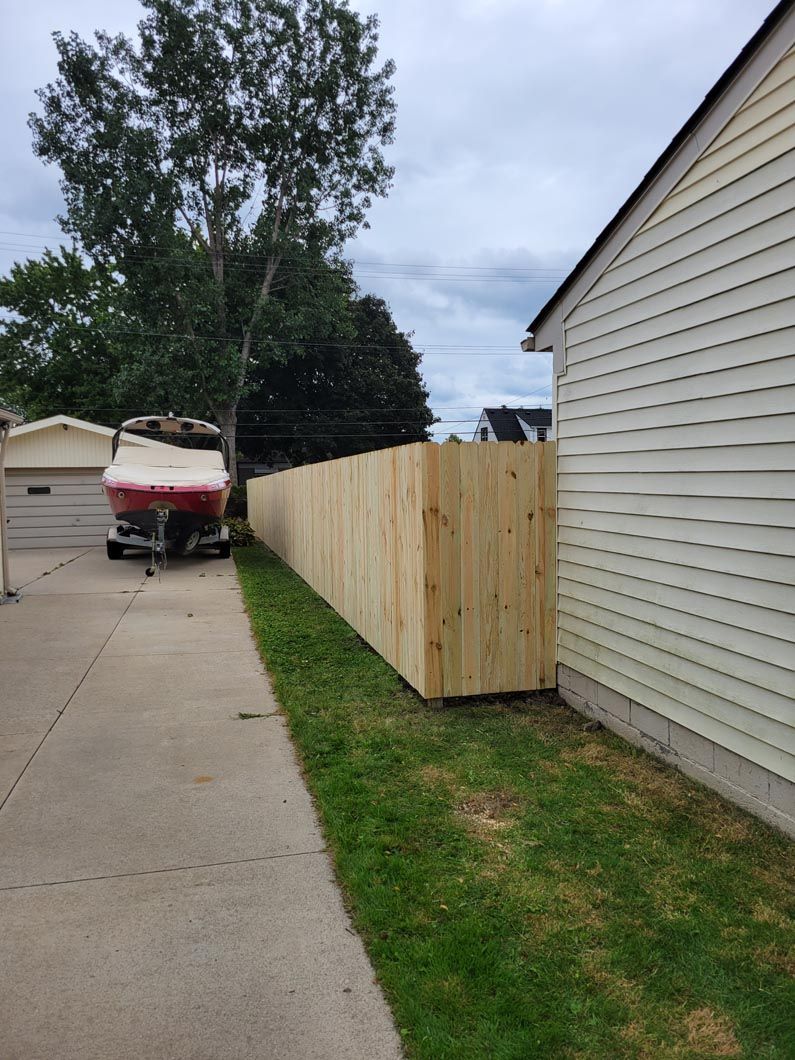 A wood privacy fence in Troy, MI in a backyard in by Elite Wood Fencing