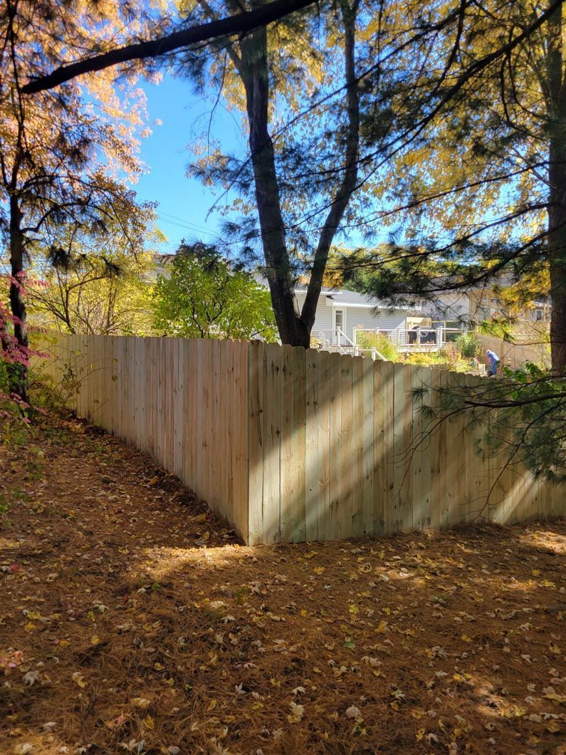 A wood privacy fence in Troy, MI in a backyard in by Elite Wood Fencing