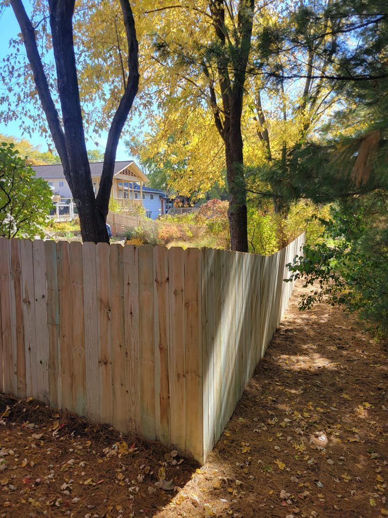 A wood privacy fence in Troy, MI in a backyard in by Elite Wood Fencing