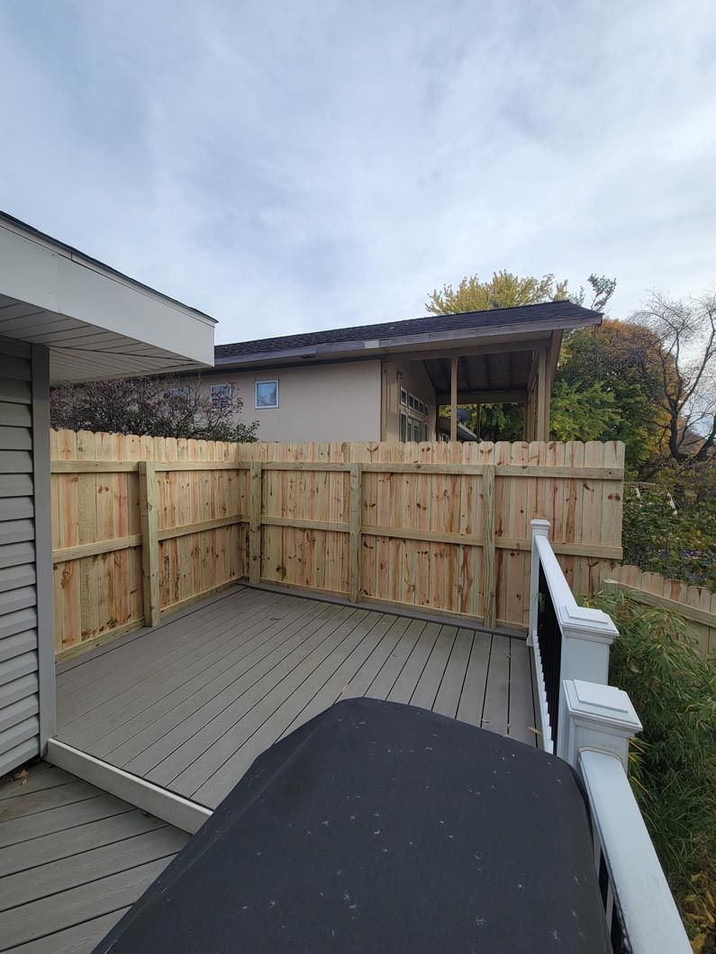 A wood fence in Troy, MI in a backyard in by Elite Wood Fencing