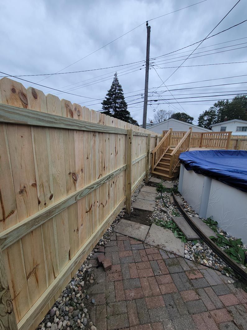 A wood privacy fence in Troy, MI for a pool by Elite Wood Fencing