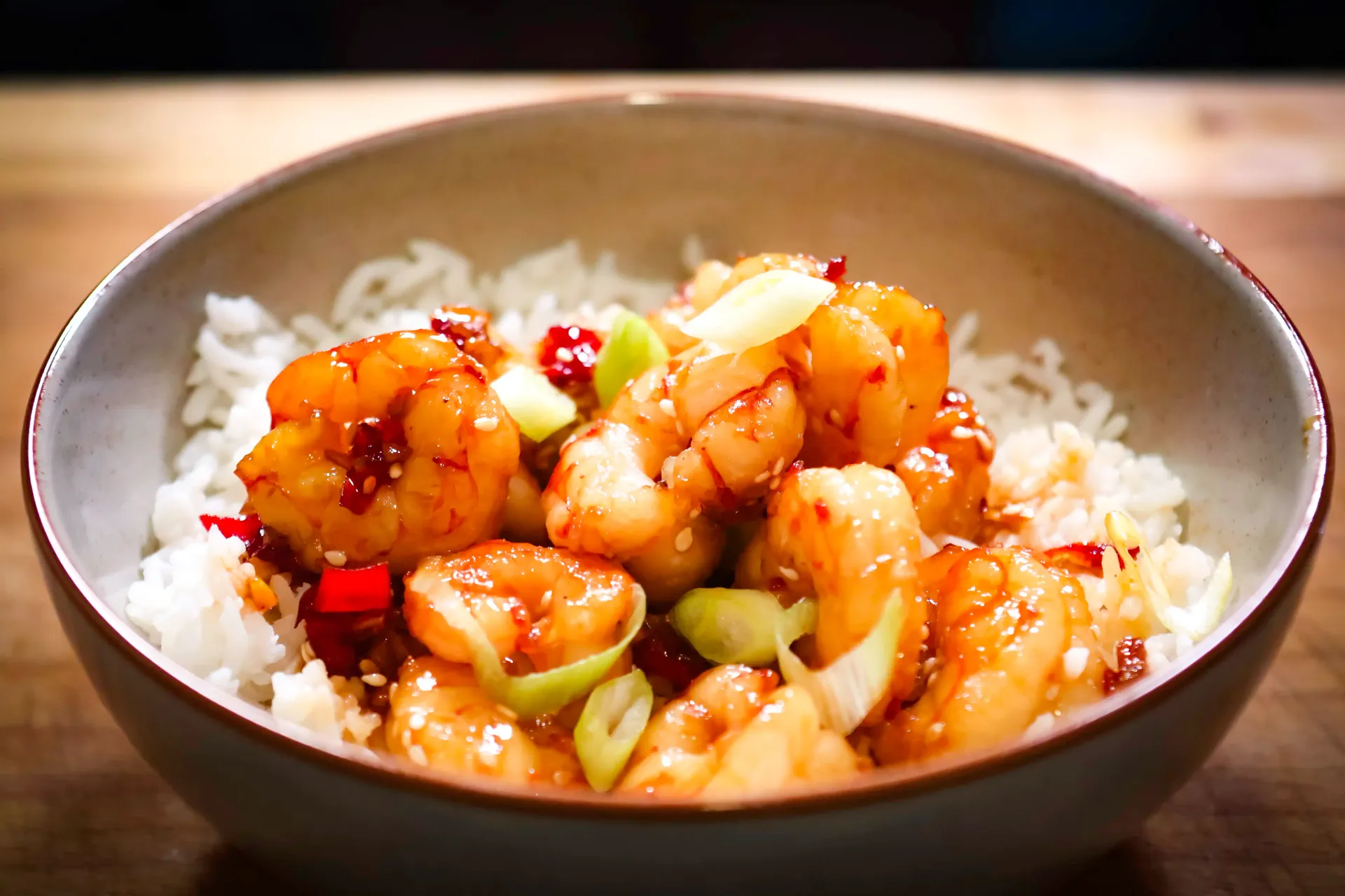 Hand sprinkling seasoning onto chopped vegetables in a stone bowl.