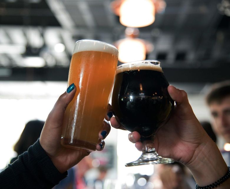 Two people are toasting with two glasses of beer
