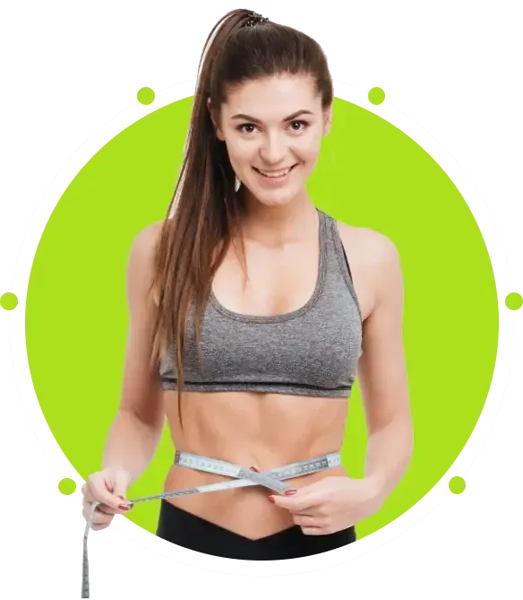 Woman in athletic wear measuring her waist, smiling. Green background.