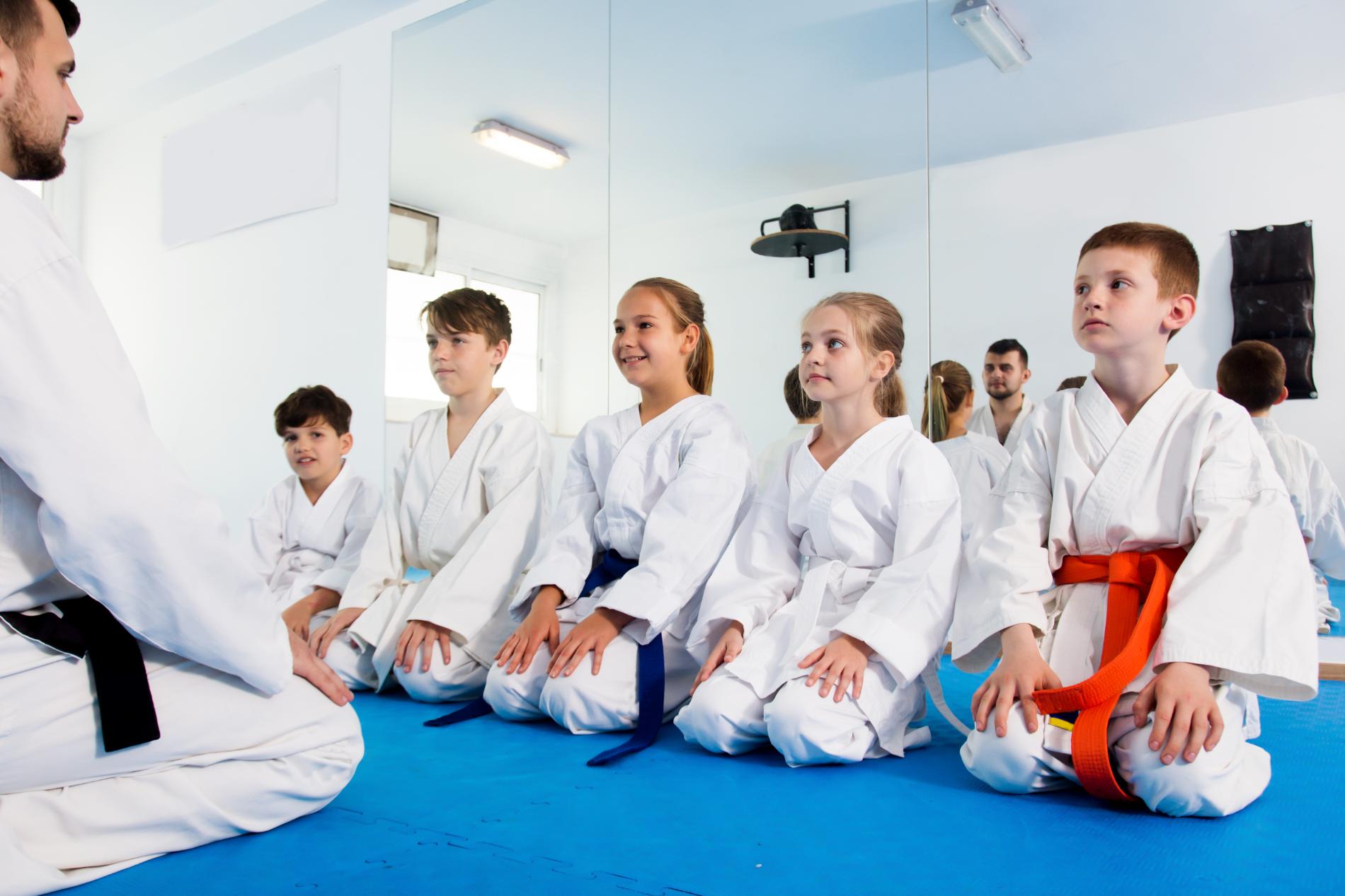 Children kneeling in karate class