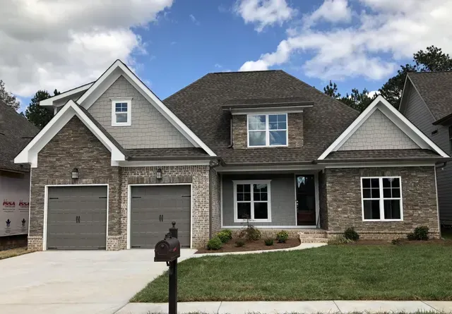 A large house with a mailbox in front of it