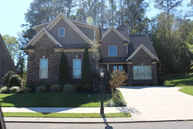 A large brick house with a driveway in front of it